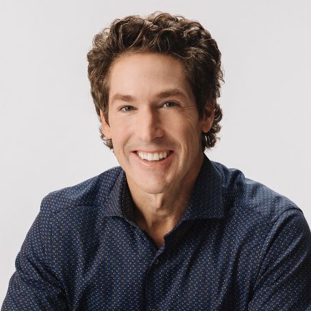 Joel Osteen in a black shirt poses for a picture.
